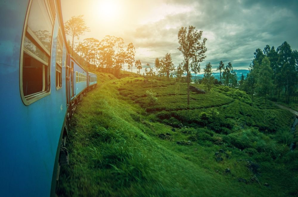 sunset over a blue train in Sri Lanka