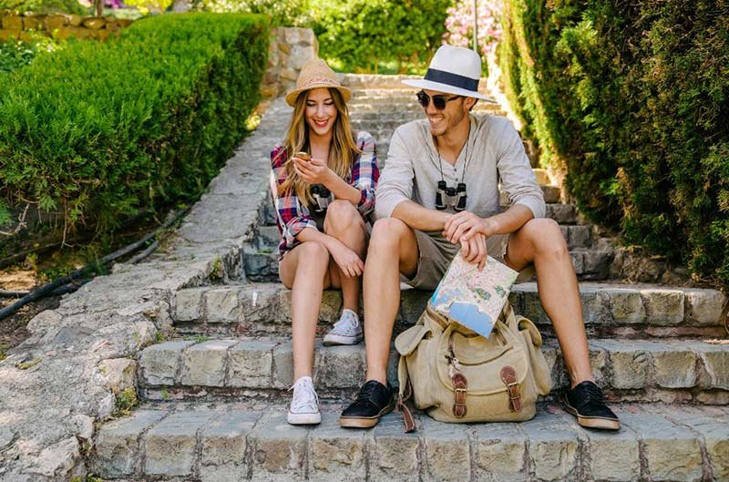 woman and man sitting on stone steps